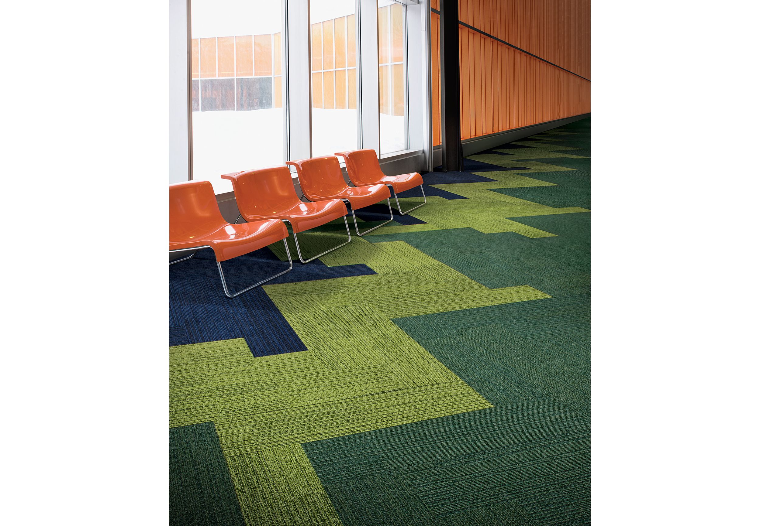 Interface On Line plank carpet tile in waiting area with orange hard plastic chairs against windows image number 4